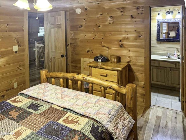 1554 Bear Valley Rd, Sevierville, TN 37876 - bedroom with wooden walls, light wood-style flooring, and ensuite bath