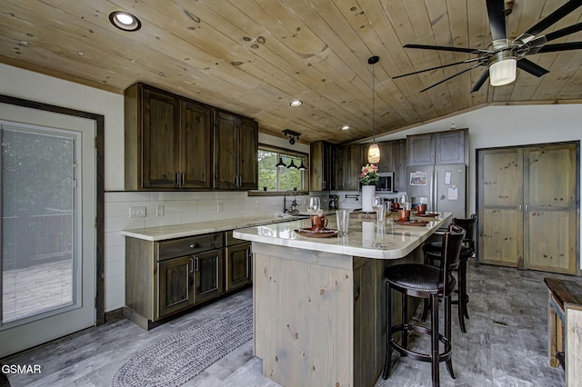 1001 Old Laurel Ln, Sevierville, TN 37876 - kitchen with wooden ceiling, ceiling fan, dark brown cabinets, light countertops, and lofted ceiling