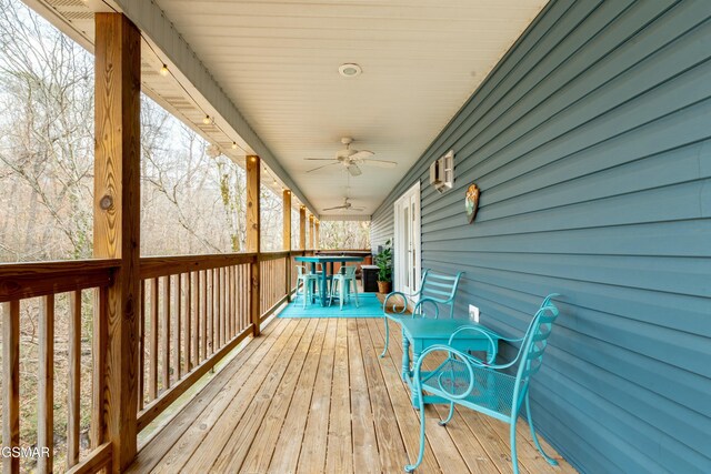 wooden deck featuring ceiling fan