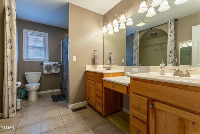 bathroom featuring tile patterned floors, toilet, and vanity