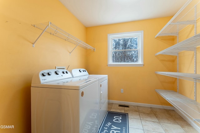 washroom featuring tile patterned flooring and washing machine and dryer