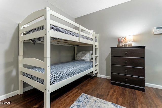 bedroom with dark hardwood / wood-style floors