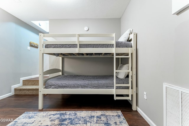 unfurnished bedroom with dark wood-type flooring