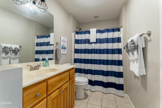 bathroom featuring curtained shower, vanity, toilet, tile patterned floors, and a textured ceiling