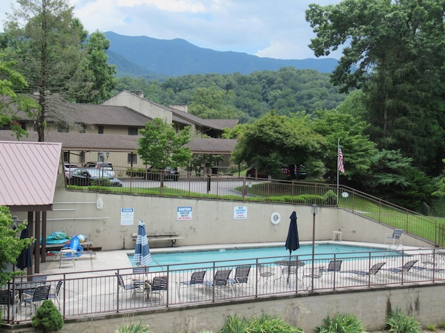 view of pool featuring a mountain view and a patio