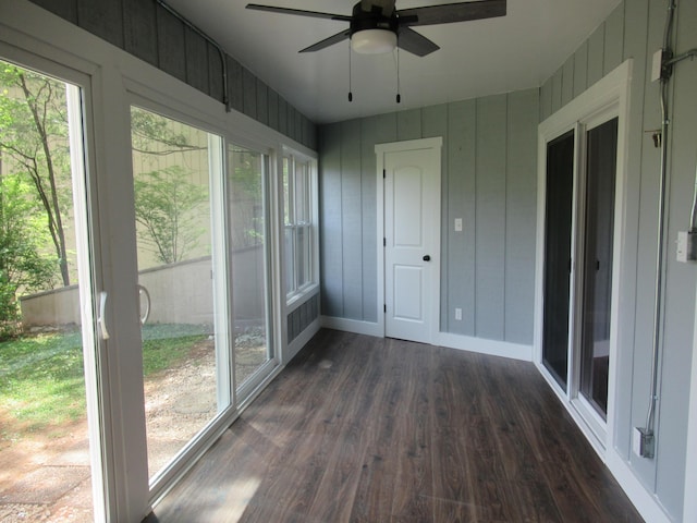 unfurnished sunroom with ceiling fan