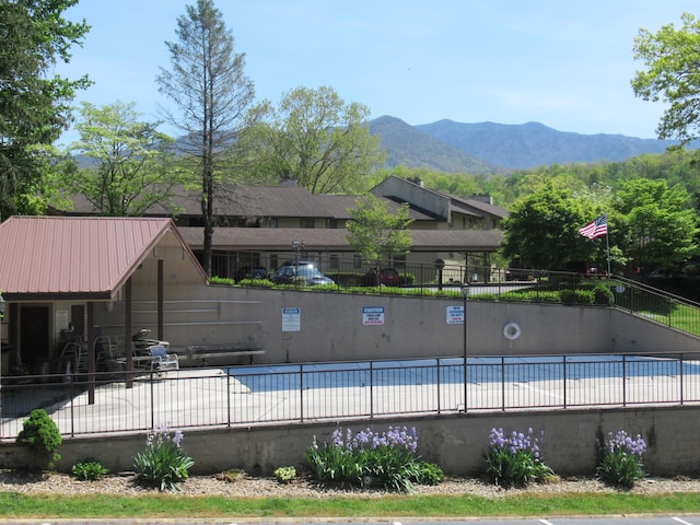 view of pool featuring a mountain view and a patio