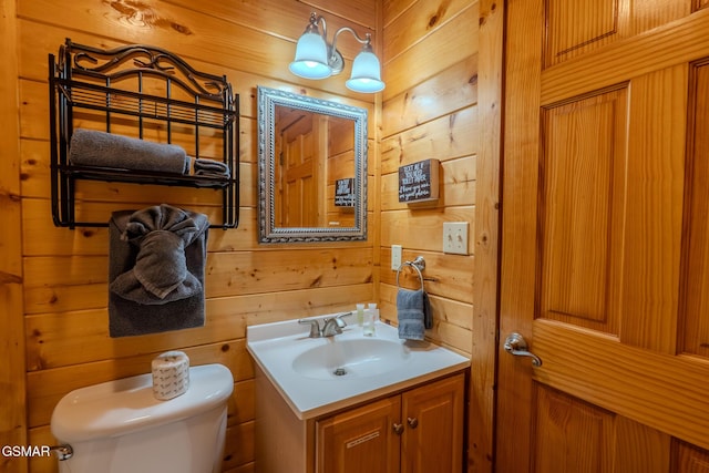 421 Laurel Ave, Gatlinburg, TN 37738 - bathroom featuring toilet, wood walls, and vanity