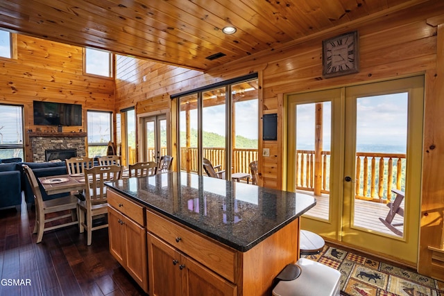 1854 Billard Way, Sevierville, TN 37876 - kitchen with french doors, wood walls, dark wood-style floors, a stone fireplace, and a kitchen island
