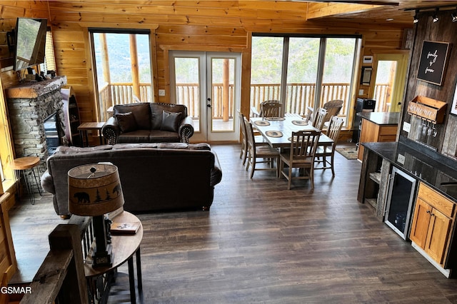 1854 Billard Way, Sevierville, TN 37876 - living room with wooden walls, a stone fireplace, plenty of natural light, dark wood finished floors, and wine cooler