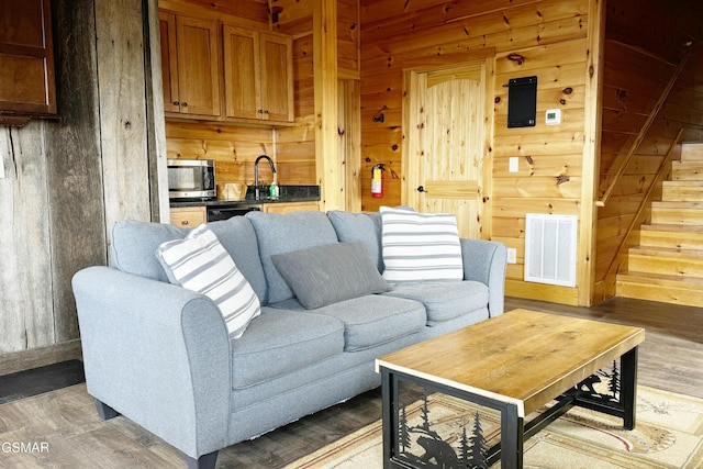 1854 Billard Way, Sevierville, TN 37876 - living area featuring wood walls, light wood-style flooring, and stairs
