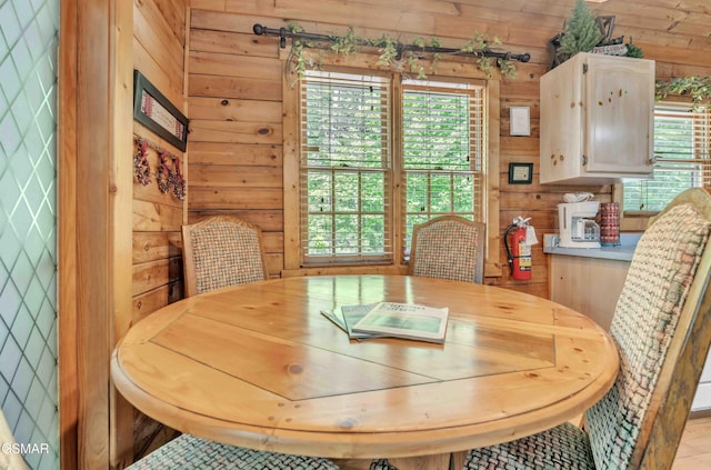 dining space with wood walls