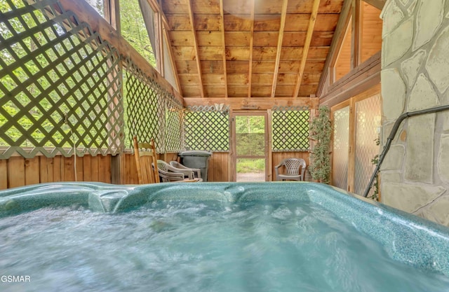 wooden terrace featuring a hot tub