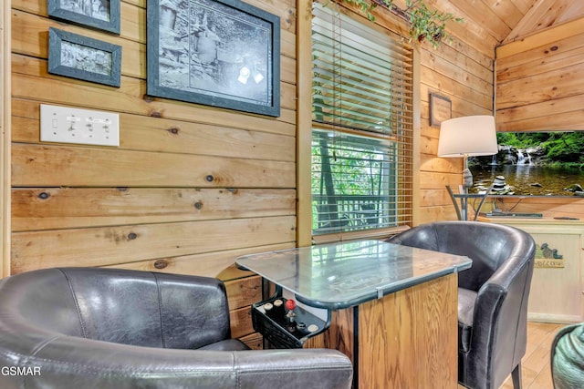 office space featuring wood finished floors, lofted ceiling, and wooden walls