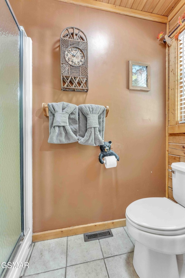 full bath featuring toilet, tile patterned floors, visible vents, and a shower stall
