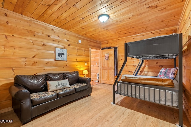 bedroom with wooden ceiling, wood finished floors, and wood walls