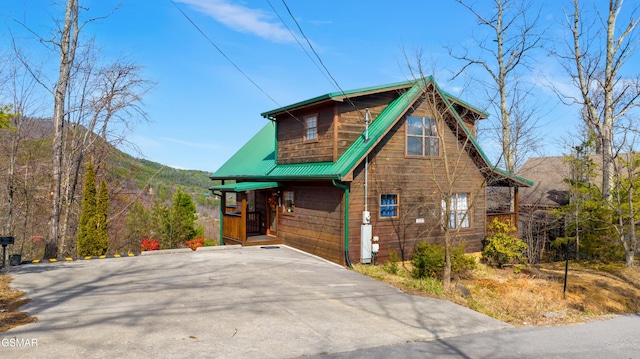 rustic home featuring metal roof