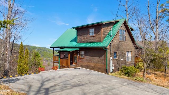 rustic home featuring metal roof