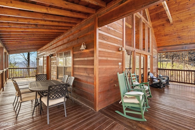 wooden deck featuring outdoor dining space and covered porch