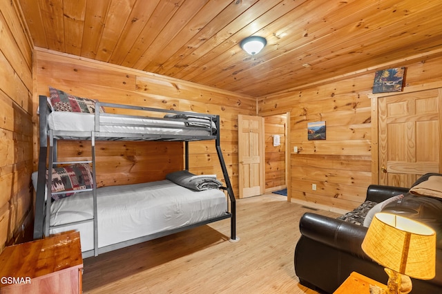 bedroom featuring wooden ceiling, wood finished floors, and wooden walls