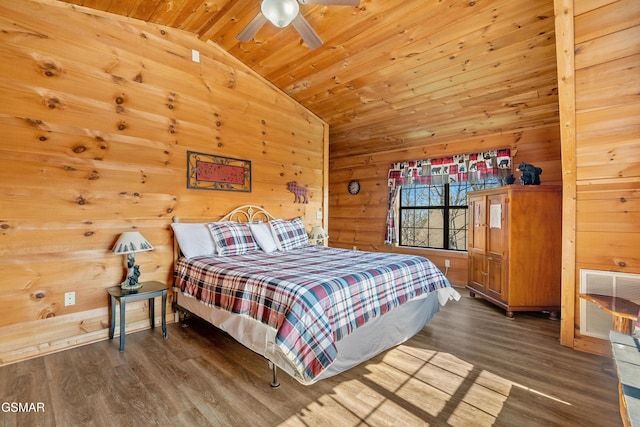 bedroom featuring lofted ceiling, wood walls, visible vents, and wood finished floors