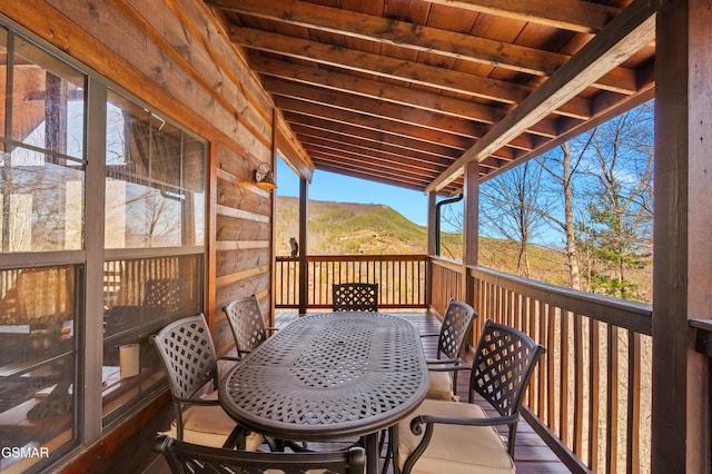 wooden terrace featuring outdoor dining area