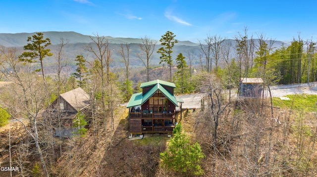 birds eye view of property with a mountain view and a forest view