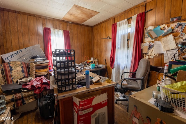 home office featuring plenty of natural light and wooden walls