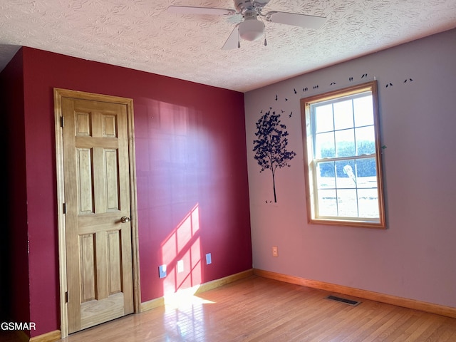 188 Riviera Dr, Newport, TN 37821 - spare room with a textured ceiling, a ceiling fan, visible vents, light wood finished floors, and baseboards