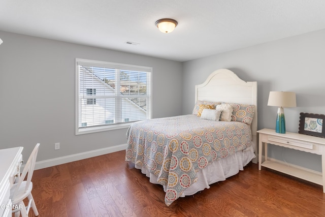 bedroom with dark hardwood / wood-style floors