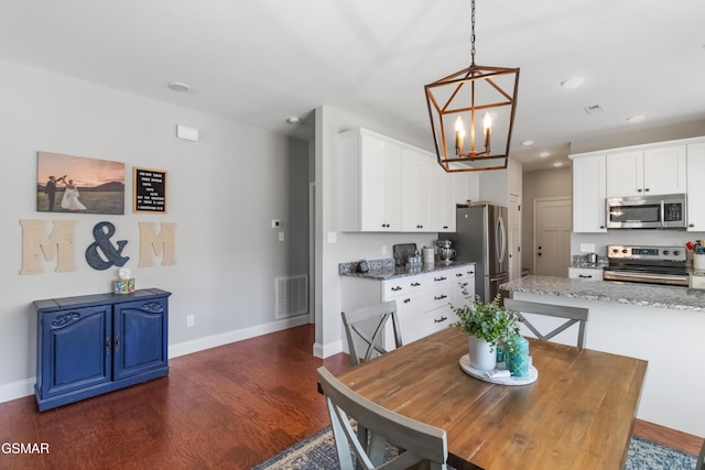 dining area with an inviting chandelier and dark wood-type flooring