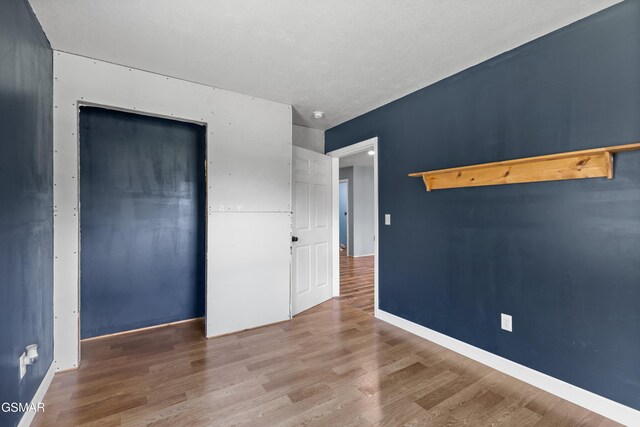 2560 Schisandra Ln, Cosby, TN 37722 - unfurnished bedroom featuring wood finished floors and a closet