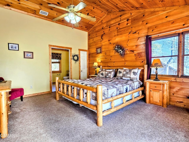 carpeted bedroom featuring baseboards, wood walls, visible vents, high vaulted ceiling, and wood ceiling