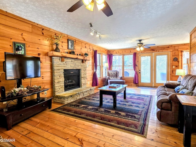 living area featuring a textured ceiling and a ceiling fan