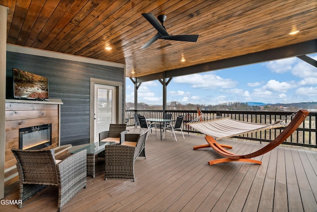 deck with ceiling fan and a mountain view