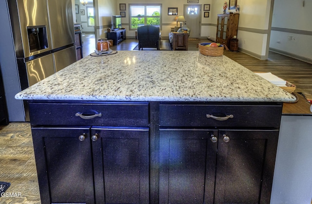 2045 Kings View Loop, Seymour, TN 37865 - kitchen with light stone counters, wood finished floors, a center island, stainless steel refrigerator with ice dispenser, and open floor plan