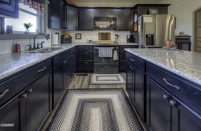 2045 Kings View Loop, Seymour, TN 37865 - kitchen featuring light stone countertops, wood finished floors, a sink, and black appliances