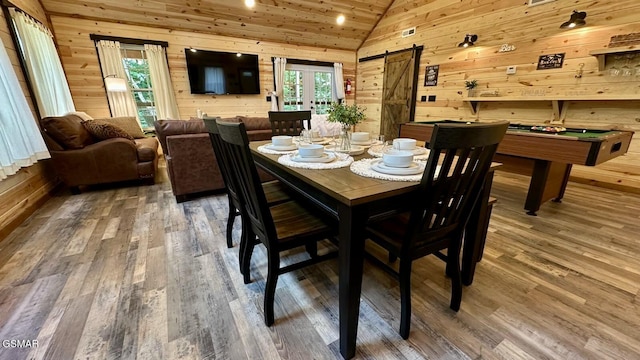 1504 Ginnys Trl, Sevierville, TN 37876 - dining space with lofted ceiling, a barn door, wooden walls, wood finished floors, and pool table