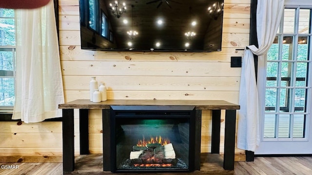 1504 Ginnys Trl, Sevierville, TN 37876 - detailed view of wood finished floors, wood walls, and a lit fireplace