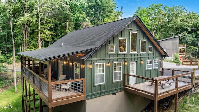 1504 Ginnys Trl, Sevierville, TN 37876 - back of property featuring board and batten siding, a shingled roof, and a wooden deck