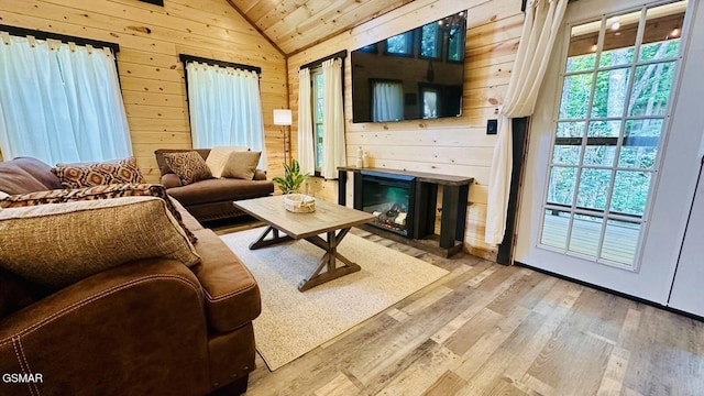 1504 Ginnys Trl, Sevierville, TN 37876 - living area with vaulted ceiling, wood walls, and light wood-style flooring