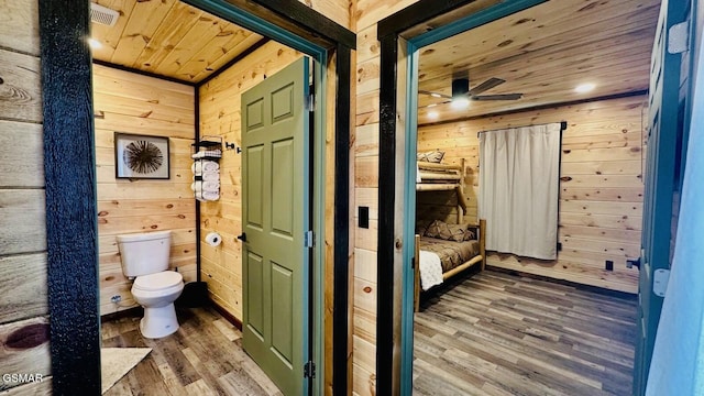 1504 Ginnys Trl, Sevierville, TN 37876 - bathroom featuring wooden walls, wooden ceiling, wood finished floors, a ceiling fan, and ensuite bath