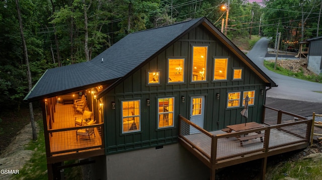 1504 Ginnys Trl, Sevierville, TN 37876 - rear view of house featuring board and batten siding, a deck, and a wooded view