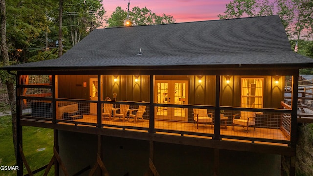 1504 Ginnys Trl, Sevierville, TN 37876 - back of house at dusk with a shingled roof, french doors, and board and batten siding