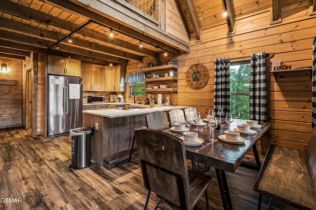 1606 Dove Wing Way, Sevierville, TN 37862 - dining area featuring a wooden ceiling with exposed beams, track lighting, wood walls, and dark wood-style floors