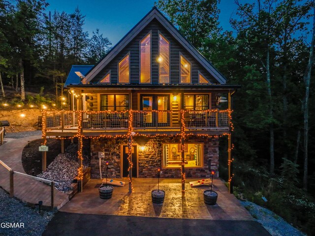 1606 Dove Wing Way, Sevierville, TN 37862 - rear view of house with a patio, stone siding, and a balcony