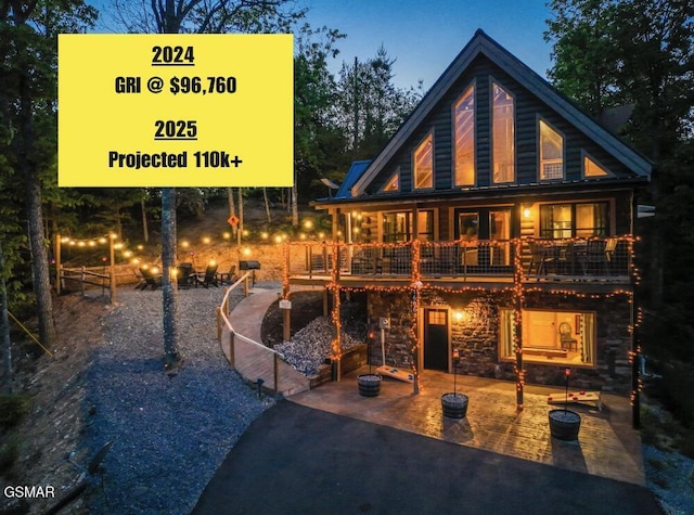 1606 Dove Wing Way, Sevierville, TN 37862 - back of house featuring stone siding and a patio