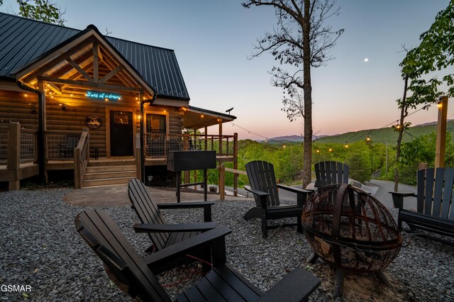 1606 Dove Wing Way, Sevierville, TN 37862 - patio terrace at dusk with a fire pit and a deck