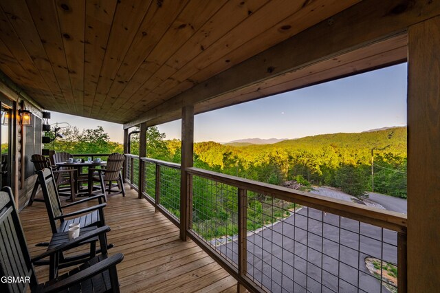 1606 Dove Wing Way, Sevierville, TN 37862 - wooden terrace featuring a wooded view and outdoor dining area