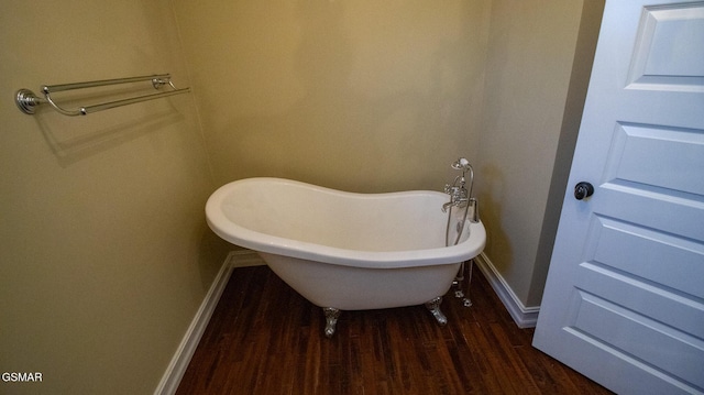 bathroom featuring a washtub and hardwood / wood-style flooring